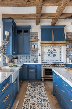 a kitchen with blue cabinets and white counter tops, an area rug on the floor