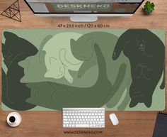 a mouse pad with two cats on it and a keyboard in front of the mouse