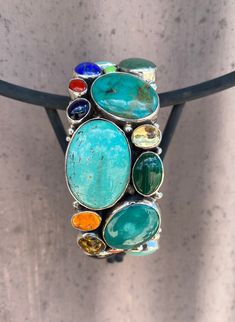 Blue Turquoise, Green Turquoise, Coral, Lapis, Citrine, oh my! So many gorgeous stones in one cuff! Vintage. Handmade in the USA. Turquoise Artisan Cuff Bracelet With Natural Stones, Artisan Turquoise Cuff Bracelet With Natural Stones, Bohemian Turquoise Bracelet With Gemstone Accents, Bohemian Turquoise Bracelets With Gemstone Accents, Blue Gemstone Cuff Bracelet, Unique Multi-stone Turquoise Gemstones, Turquoise Green, Green Turquoise, Blue Turquoise