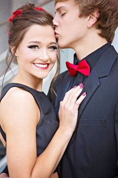 a man and woman kissing each other in front of an instagramr with the caption's name on it