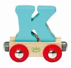 a wooden toy train with the letter k on it's front wheel and red wheels