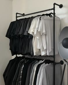 an ironing rack with clothes hanging on it