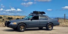 a gray truck parked on top of a dirt road