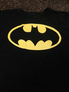 DC Comics Batman black T-shirt, kid size XXL (18) black. Short sleeve, no stains,  rips or tares.  Condition is Pre-owned. Shipped with USPS First Class Package. Black Tops With Screen Print For Fan Conventions, Black Screen Print Tops For Fan Conventions, Pop Culture Black T-shirt For Fan Merchandise, Black Pop Culture T-shirt For Fan Merchandise, Black Letter Print T-shirt For Fan Conventions, Black Graphic Tee For Fan Conventions, Black Band Merch Tops For Fan Conventions, Band Merch Black Tops For Fan Events, Black Graphic Print Top For Fan Conventions