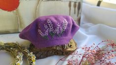 This lavander embroidered purple french beret is perfect for cold days and makes an adorable keepsake than can be treasured forever. Purple French Beret. There is a completely handmade embroidery on the caps. I made lavander embroidery pattern. **Have a look at my other products here: https://www.etsy.com/shop/BTtasarim?ref=simple-shop-header-name&listing_id=1320295533 ✨ Other Hand embroidered beret models⬇️ https://www.etsy.com/listing/1319308048/vintage-wool-french-beret-hand?click_key=3f7321488fb515b5282cd0d1e97ed983fdeec11e%3A1319308048&click_sum=78912ebf&ref=shop_home_feat_4&pro=1 By purchasing my unusual and unique products; You can make a nice gift for yourself or your loved ones. Material: 100% wool, solid and thick Size: one size fits most for women Embroidery: 100% hand made with Handmade Purple Hat As Gift, Handmade Purple Hat For Gift, Purple Cap As A Gift, Purple Hat For Spring Gift, Purple Hat For Spring As A Gift, Purple Hat As A Spring Gift, Purple Spring Gift Hats, Embroidered Beret, Purple Beret