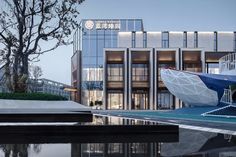 a building with a large boat in front of it's entrance and water reflecting on the ground