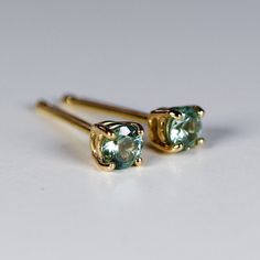 "14k yellow gold and 3mm calibrated Montana sapphire stud earrings. They will make a great companion to your beautiful wedding. They are very elegant for daily use or for official gatherings. SOLD AS PAIR. Available white gold or yellow gold from drop down menu. Material; 14k solid gold studs Round Montana Green sapphire 3mm. These are calibrated stones, so they are exactly 3mm. Prong settings. 14k gold backings included. ------------------------------------ GIFT WRAPPING My regular package is o Sapphire Jewelry Set, Green Montana, Sapphire Stud Earrings, Blue Opal Ring, Sapphire Earrings Studs, Sapphire Studs, Montana Sapphire, Green Sapphire, Earrings Wedding