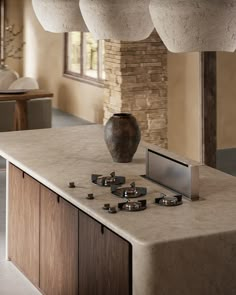 a kitchen with a large vase on top of the counter next to some burners