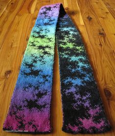 two knitted ties sitting on top of a wooden floor