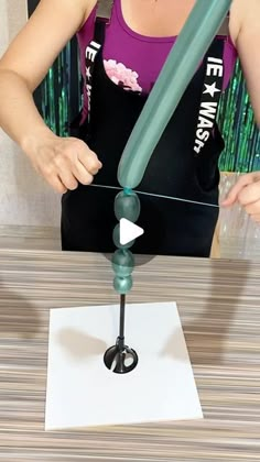 a woman is making a sculpture out of plastic