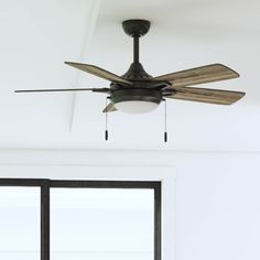 a ceiling fan that is hanging from the ceiling