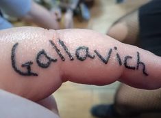 someone has written the word golevin on their finger