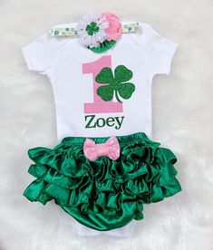 This listing is for Baby girl's Irish -St Patrick's theme First Birthday outfit . Includes Bodysuit, Bloomerskirt (ruffles all around )and headband . Name can be added on the bodysuit. Please leave a note in the note to seller box upon checkout for personalization. Bodysuit used is carter's brand . Carter's Bodysuit is Crafted in babysoft cotton, Easy to change with Nickel-free snaps on reinforced panels . All outfits are made to Order and Normal PROCESSING time is 2 weeks. *Processing time DOES First Birthday Fitted Sets With Ruffles, Cute Diaper Cover For First Birthday, Cute Ruffled Sets For First Birthday, Pink Ruffled Birthday Set, Cute Ruffled Sets For Birthday, Fitted Birthday Sets With Ruffles, Fitted Sets With Ruffles For Birthday, White Ruffled Birthday Set, White Ruffled Sets For Birthday