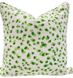 a green and white pillow with spots on it