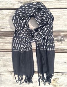 The perfect gift for the man or woman in your life, the Classic Black Ikat Scarf is lightweight, ethically made, and features tassels at the ends. Your purchase helps provide a secure job with fair wages and a positive working environment to artisans in Bangalore and Andhra Pradesh, India. *Hand woven and Ikat dyed *100% cotton *Fair trade & made in India *Scarf measures: 22" wide by 75" long *Due to the handmade nature of these products there may be a 5-10% shade variation from the picture Vintage Scarf Ideas, Ikat Scarf, Bridal Hijab, Crochet Sun Hat, Fall Nights, Womens Scarf, India Design, Scarf Women Fashion, Silk Ikat