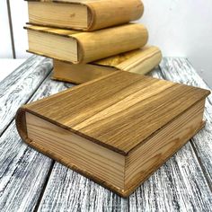 three wooden books are stacked on top of each other