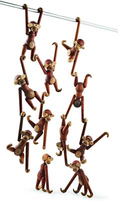 monkey figurines hanging on clothes pins in the shape of people with hands and feet