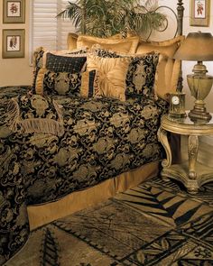 a large bed covered in black and gold comforters