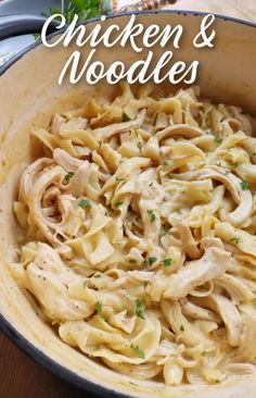 chicken and noodles in a skillet with parsley on the side for garnish