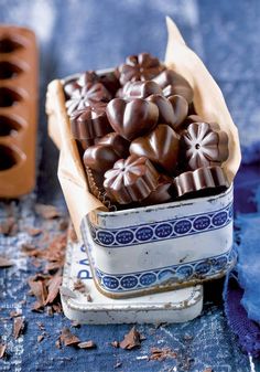 chocolates in a blue and white bowl on a table