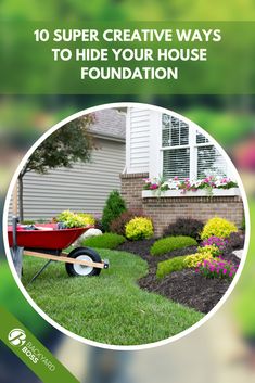 a yard with flowers and a wheelbarrow on the grass, in front of a house