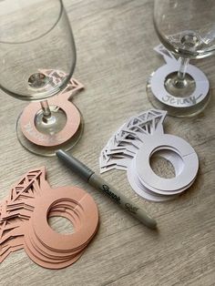 paper cutouts and wine glasses sitting on a table