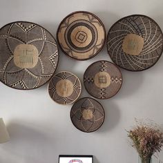 a desk with a computer on it and several baskets hanging from the wall behind it