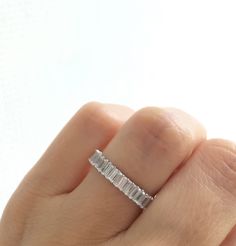 a woman's hand with a diamond ring on it