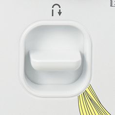 a close up of a white wall mounted device with an arrow pointing to the left