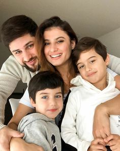 a man, woman and two children posing for the camera