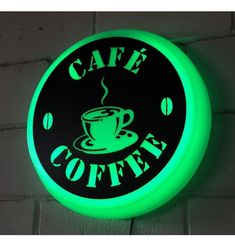 a neon sign that says cafe coffee with a cup of coffee in the center on it