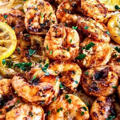 grilled shrimp with lemon wedges and parsley