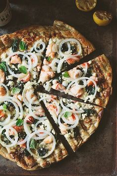 a pizza sitting on top of a pan covered in toppings