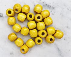 yellow beads are arranged on a marble surface