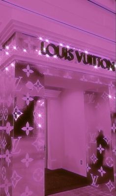 the entrance to louis vuitton is lit up in pink and purple lights,