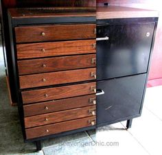 a black and brown dresser sitting next to each other on top of a tile floor