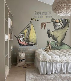 a child's bedroom with a mural on the wall