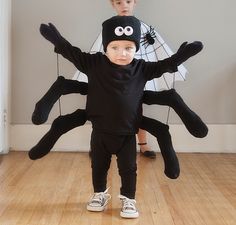 a little boy in a black spider costume