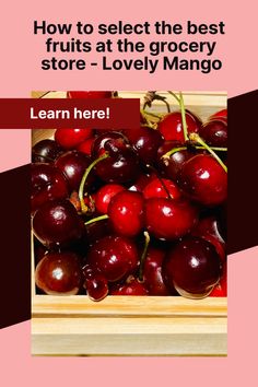 a wooden box filled with lots of cherries on top of a pink and red background