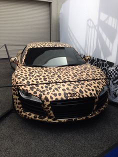 an animal print car parked in front of a building