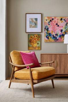 a living room filled with furniture and pictures on the wall