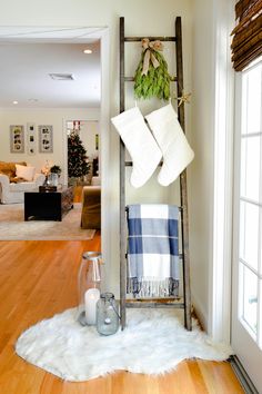 a living room with a ladder and christmas decorations