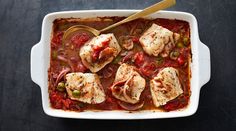 a casserole dish with fish and vegetables in it, ready to be eaten