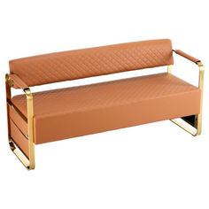 a tan leather bench with gold metal legs