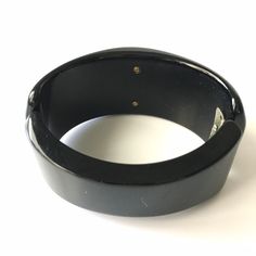 "Item: This is a fabulous black bakelite clamper bangle bracelet with a reverse carved apple juice flower cabochon mounted in the center. It's in excellent condition, has been tested and guaranteed vintage bakelite. Be sure to check our other listings for lots more bakelite jewelry! Measurements: 1 1/4\" wide in front - 2 1/4\" inner oval diameter, 6 3/8\" inner circumference. Condition: 9.5 - Excellent Shipping: US buyers pay $14.95 for Fully Insured USPS Priority Mail with Tracking. Internatio Bakelite Jewelry, Vintage Bakelite, Dress Clip, Silver Dress, Rhinestone Bracelet, Antique Art, Vintage 1950s, Bangle Bracelets, Vintage Jewelry