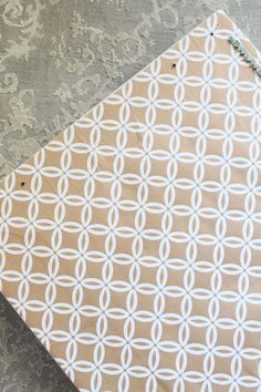 a piece of brown paper with white circles on it sitting on top of a table