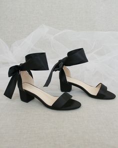 "Classy satin block heel with satin ribbon ankle tie. Simple yet elegant are great combination and will definitely be a favorite. DETAILS: FIT: RUNS LARGE, ORDER ONE SIZE DOWN HEEL HEIGHT: 1.5 inch (Kids) & 2 inches (Women) RIBBON WIDTH: 1.5 inches COLORS AVAILABLE: Black, Burgundy, Champagne, Ivory, Navy, White, Light Blue, Soft Blush UPPER: Synthetic upper and lining MATERIALS: Mandmade outsole STYLE NAME: NAOMI KIDS SIZES: Size 11- 7.65 inch Size 12 - 7.85 inch Size 13 - 8.15 inch Size 1 Black Bridesmaid Shoes, Bridesmaids Shoes, Kids Heels, Tie Heels, Holiday Shoes, Satin Noir, Short Heels, Bridal Heels, Bridesmaid Shoes