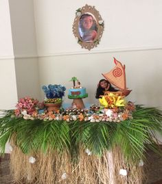 a table topped with lots of fake plants and decorations