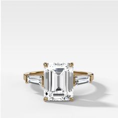 an emerald - cut diamond ring with baguets