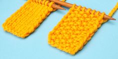 two knitting needles are hooked up to the ends of yellow knitted pieces on a blue surface